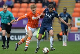 Blackpool's Brad Potts battles with Southend United's Will Atkinson