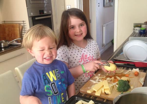 William Mellor (left) with his sister Gracie helping with the Sunday dinner