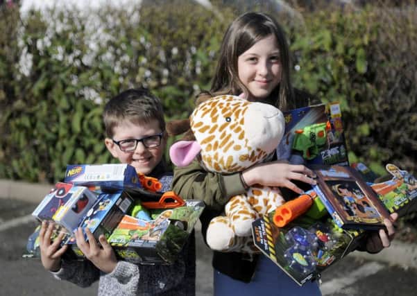 Opening of the new Smyths toy store.  Harry Sheridan, 7, and Jennifer Sheridan, 12, with some of their bought toys.