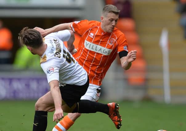 Blackpool's Jim McAlister battles with Colchester United's Joe Edwards