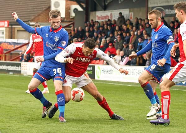 Fleetwood Town's Antoni Sarcevic vies for possession with Oldham Athletic's Cameron Dummigan
