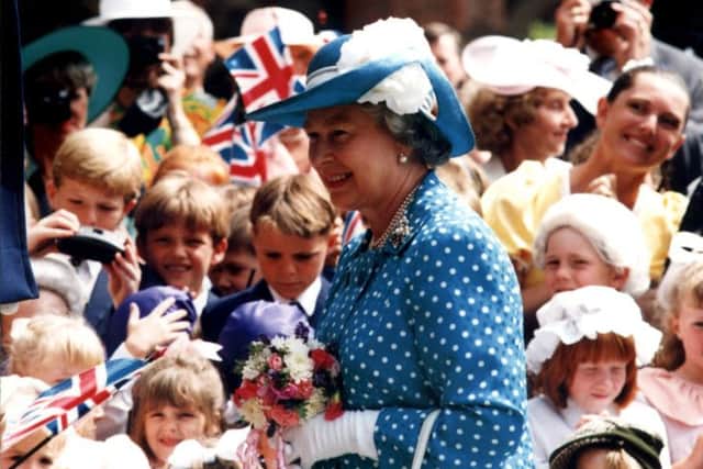 The Queen is greeted by excited children at Rossall school, in 1994.