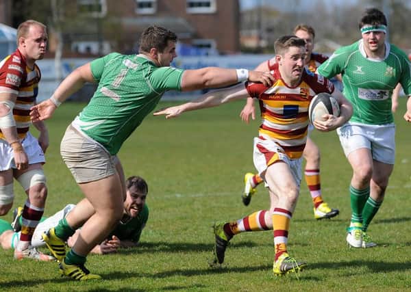 Greg Nicholls evades the clutches of the Wharfedale defence