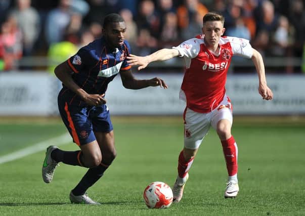 Fleetwood Town's Ashley Hunter battles with Blackpool's Hayden White