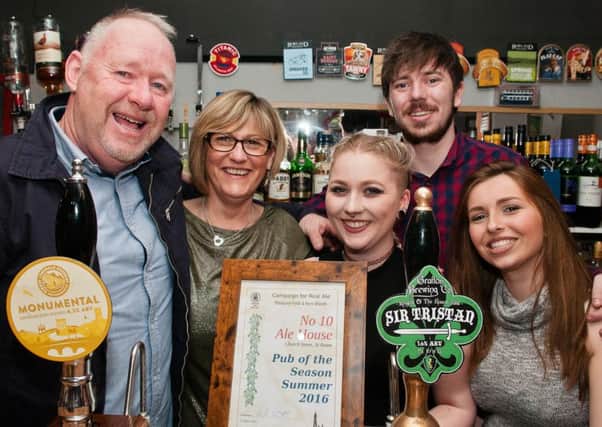 George Smith, landlord of the No 10 Alehouse, St Annes, celebrates the CAMRA branch pub of the season award with wife Alyson and bar staff