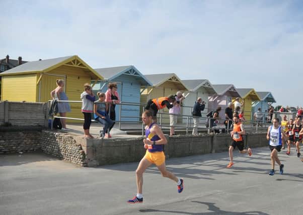 Fleetwood Half-Marathon. The start- runners pass the beach huts.