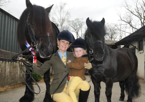 Award winning horse rider Caroline Bradley with horse Sonny (left), pictured  with daughter Amelia-Grace, two, and her pony Rosie, at Stanah Hores Feeds stables, Thornton.