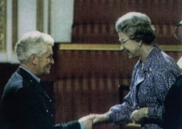 James Robert Williams receives his MBE from the Queen in 1991