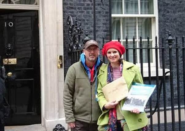 Gayzer Frackman serves legal notice on the Prime Minister about health risks of fracking and how legal action will be taken if  Communities minister Greg Clarke allows fracking to go ahead on the Fylde. Also pictured is and Emily Shirley  of SaFE, the Safety in Fossil Fuel Exploitation Alliance