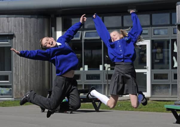 Year 6 pupils at Mereside Primary School celebrate after being ranked in the top 20% of schools nationally for reading, writing and maths by the SSAT.  Pictured are Makenzie Davis-Jones, 10, and Rhiannon Morrison, 11.