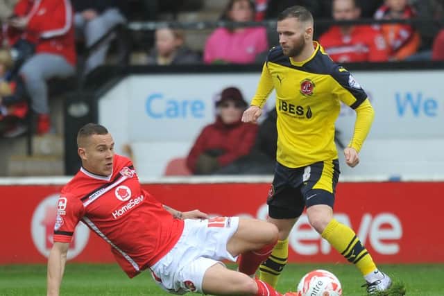 Fleetwood Town's Jimmy Ryan is tackled by Walsall's Kieron Morris