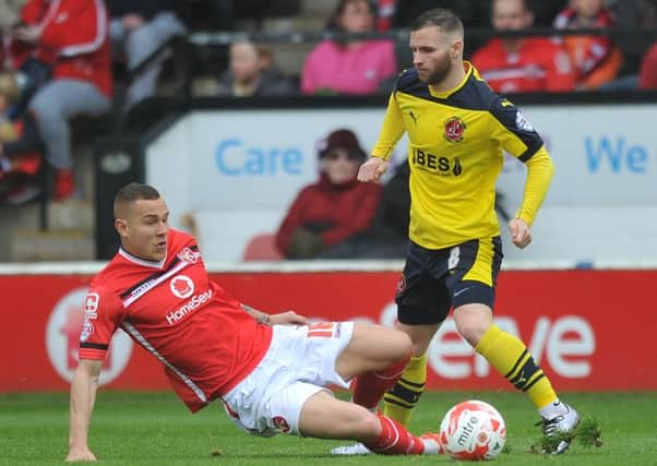 Fleetwood Town's Jimmy Ryan is tackled by Walsall's Kieron Morris