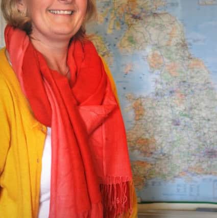 Cancer survivor Sue Wood, of Denmark Road in Ansdell, will visit all 69 cities in the country to raise funds for the Blue Skies Hospital Fund.
Sue consults her map.  PIC BY ROB LOCK
6-5-2016
