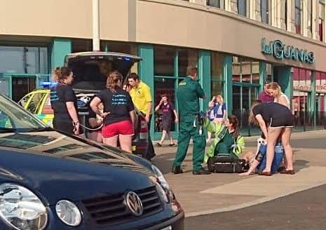 A reveller is treated by paramedics yesterday afternoon