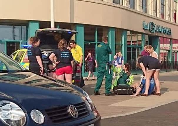 A reveller is treated by paramedics on Sunday afternoon