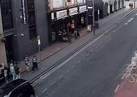 A CCTV image released by police show two women, bottom left, wheeling away the bike
