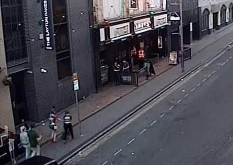 A CCTV image released by police show two women, bottom left, wheeling away the bike