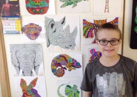 Ollie with some of his artwork