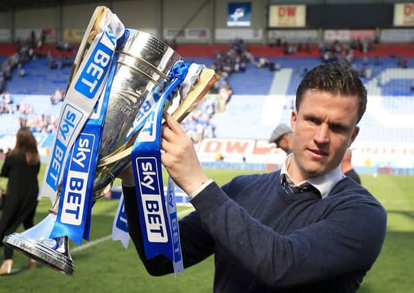 Wigan Athletic manager Gary Caldwell celebrates with the Sky Bet League one trophy following the Sky Bet League One match at the DW Stadium, Wigan. Nigel French/PA Wire.