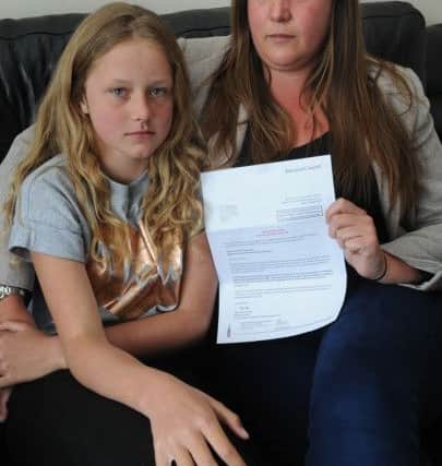 Michelle Smith, of Thornton Gate in Cleveleys, was fined by her daughter's school after taking her out during term-time because its holidays did not coincide with those of another of Michelle's children. Michelle is pictured with her fine notice and daughter Amelia.
