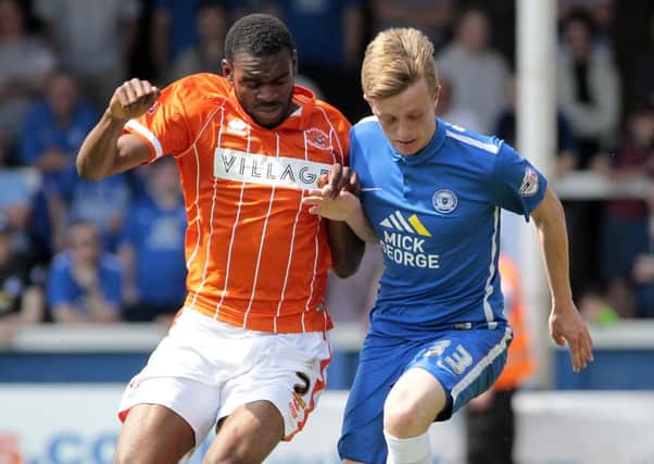 Blackpools Hayden White battles with Peterborough United's Chris Forrester
