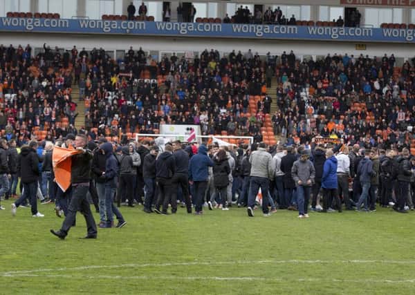 Blackpool fans stage a protest and pitch invasion against the running of the club by owner Owen Oyston. The match was later abandoned
