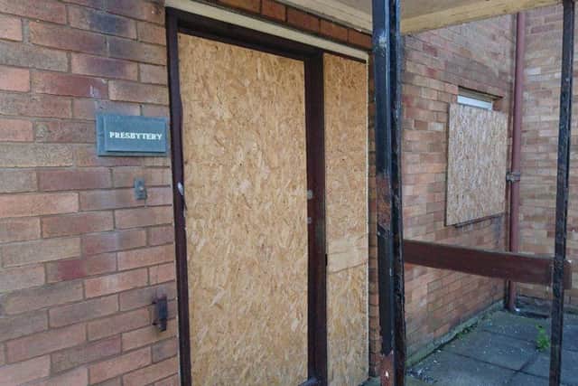 A boarded up door and window at Christ the King's presbytery, in Gateside Drive, Grange Park