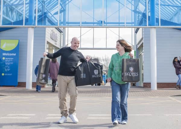 Paul Darlow with his wife Sian and all his new clothes
 at Freeport Fleetwood. Pics: Tarleton Photography