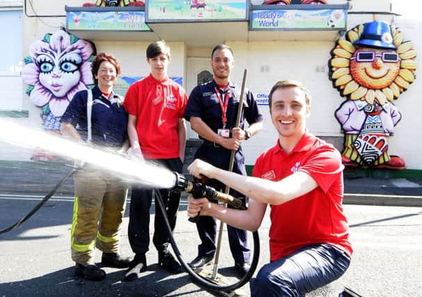 Members of the Prince's Trust help tidy up Donna's Dream House.  Prince's Trust member Andy Mollins with firefighter Jayne Hinkley, Jack Jones and Raymond Beesley, team leader for Lancs Fire and Rescue Princes Trust.