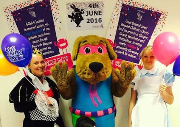 Houndshill staff get in the mood for One Great Day in Wonderland (Jen Banister (Queen of Hearts) Claire Purcell (Alice) and Harry the Hound (Centre Mascot)