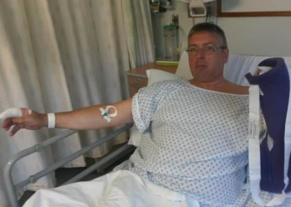 John Gregory in hospital recovering from a dog attack which left both hands bloodied