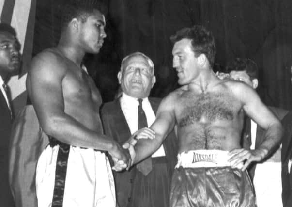 London (right) shakes hands with Ali in 1966