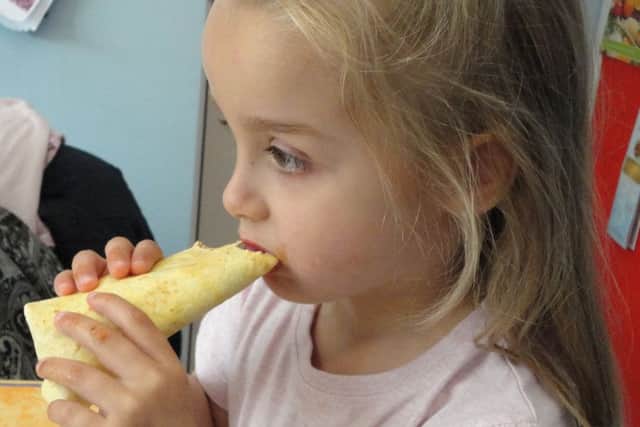 Madison, four, tries her first home made taco