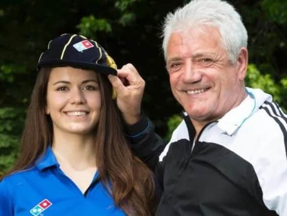 Former England football player and manager Kevin Keegan "caps" new employee Eva Juhasz, as she joins the Domino's team, which marks the pizza chain's creation of 10,000 new jobs to deal with demand from football fans during UEFA Euro 2016. Picture by: Jon Super/PA Wire