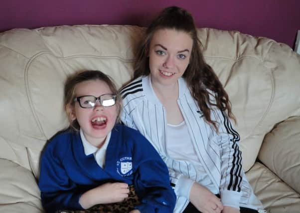 Jessica Smith, 10, and big sister Caitlin, 14, one of her carers