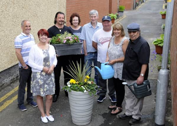 Community workers and residents have transformed an alleyway close to Sherbourne Road thanks to funding from the Health Lottery.  Pictured are members of Claremont Ten.