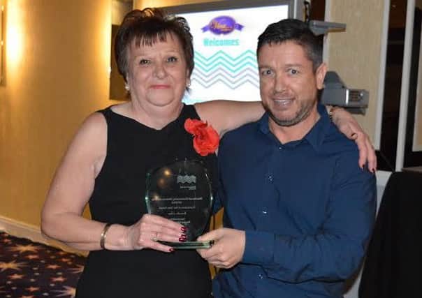Brenda Giles receives her Fundraiser of the Year award from Blackpool Coastal Housing sponsored and presented by Martin Read of Read and Errington Ltd who sponsored that award.