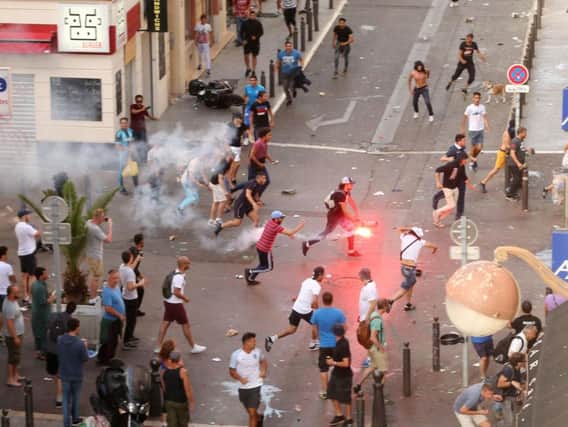 A fan runs with a flare ahead of the England vs Russia France Euro 2016 match, in Marseille, France (Pic: Niall Carson/PA Wire)