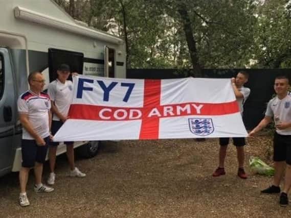 From left to right, Mark Ratcliffe, Kevin Morris, Sam Ratcliffe, and a friend, with a flag they had made for Euro 2016