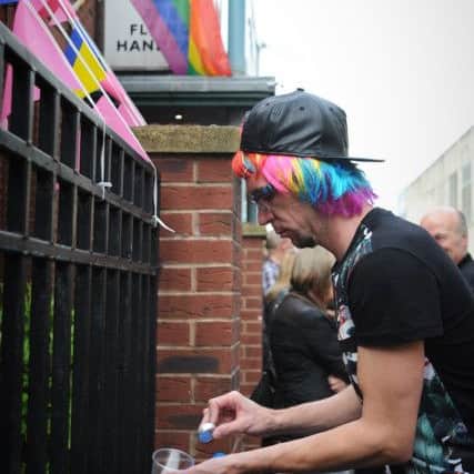 Members of Blackpool's LGBT community held a vigil outside the Flying Handbag pub to mourn the victims of Orlando's mass shooting. Lighting one of the fifty candles while the flag flies at half-mast