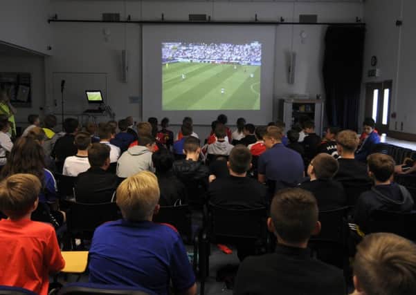 Pupils from St George's Academy watch the England v Wales football match