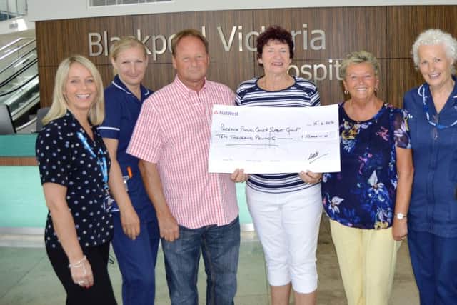 Diana with her cousin Brian and Sandra Peet, Nicola Seymour (far right) and staff from Blackpool Victoria Hospital with the cheque for Â£10,000