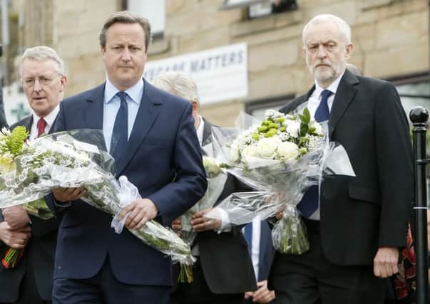 Prime Minister David Cameron and Labour Party leader Jeremy Corbyn lay flowers