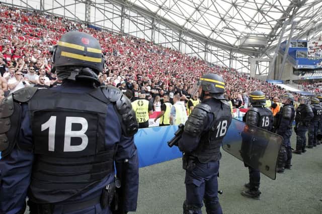 French police secure the pitch of the Velodrome stadium after minor clashes with Hungarian fans before the Euro 2016 Group F soccer match between Iceland and Hungary in Marseille, France, Saturday, June 18, 2016. (AP Photo/Thanassis Stavrakis)