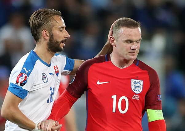 Wayne Rooney (right) and Slovakia's Dusan Svento