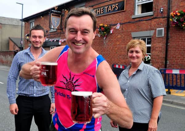 Tim Armit raring to go for the first Lytham Beer Run, cheered on by The Taps manager, Ryan Norris and supervisor Bev Nicholson