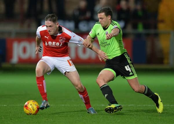 Fleetwood Town's Declan McManus holds off Sheffield United's James Wallace