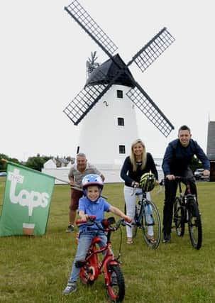 Four year old Henry Swift of Lytham in training for this year's Taps Bike Ride, watched by (from left)Taps landlord Steve Norris,  Fiona Swift and Luke Norris