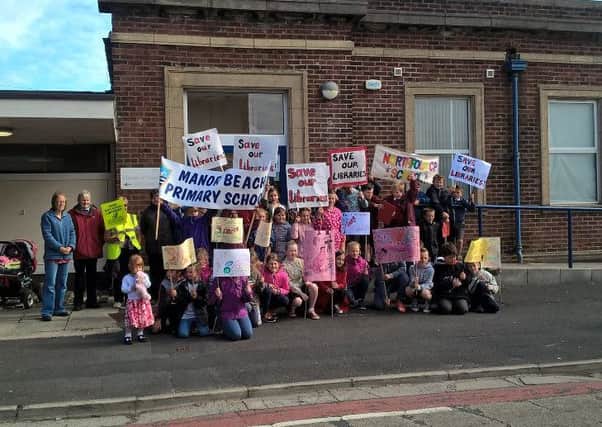 Pupils from Manor Beach and Northfold stage their library protest march