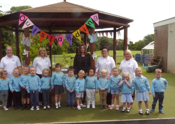 Youngsters and staff at St Peter's Nursery celebrate an outstanding Ofsted report